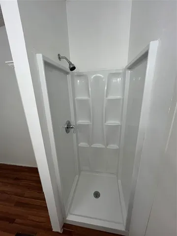 a bathroom with a glass door shower