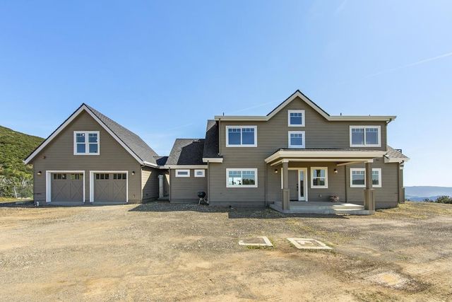 a view of a town with mountains in the background
