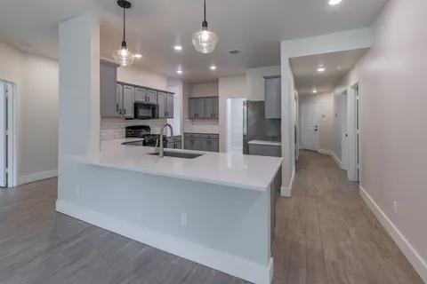 a view of a kitchen center island cabinets and stainless steel appliances