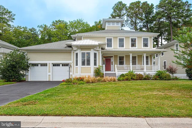 a view of a patio with chairs and floor to ceiling window with wooden floor