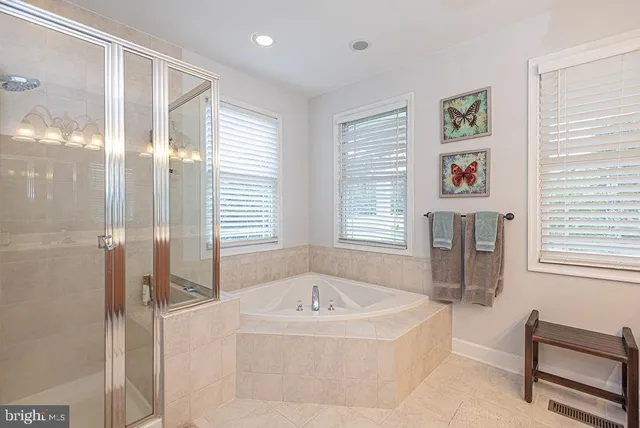 a living room with furniture a fireplace and a chandelier