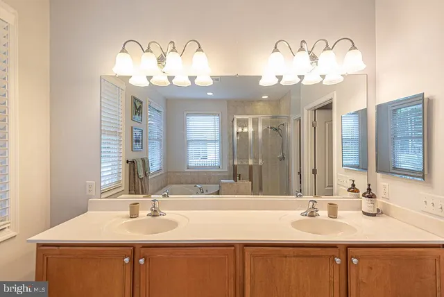 a view of a house with large windows and wooden fence