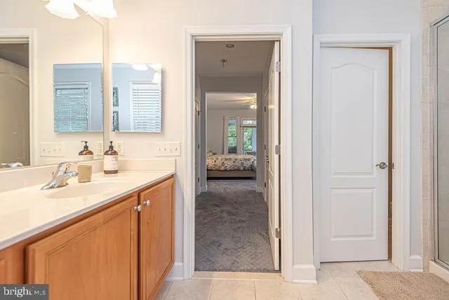 an aerial view of a residential houses with outdoor space and trees all around