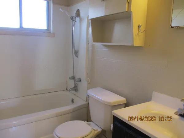 a bathroom with a toilet a sink and bathtub
