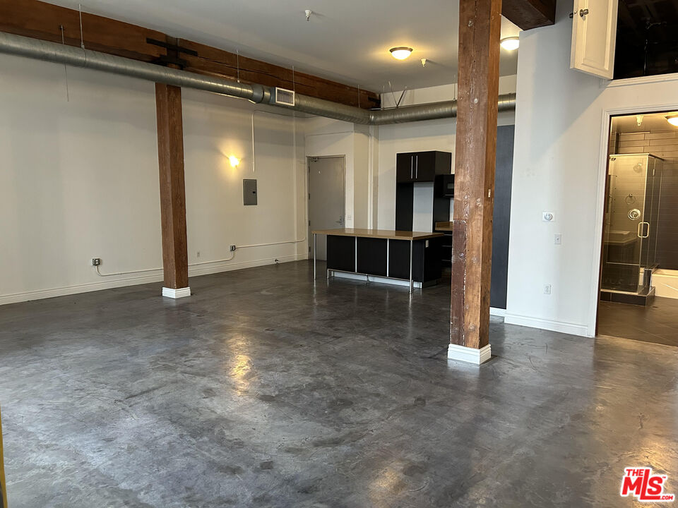 652 Mateo Street, Unit 101 Los Angeles, CA 90021 - Photo 4 of 8 a view of a hallway with wooden shelves