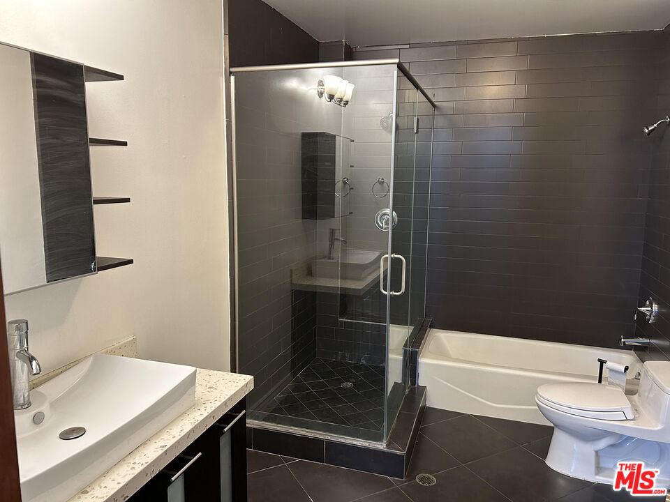 652 Mateo Street, Unit 101 Los Angeles, CA 90021 - Photo 5 of 8 a bathroom with a sink and a mirror