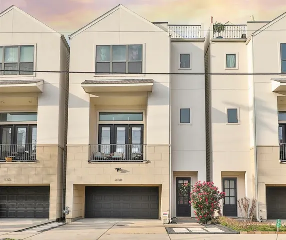 a front view of a building with a garden