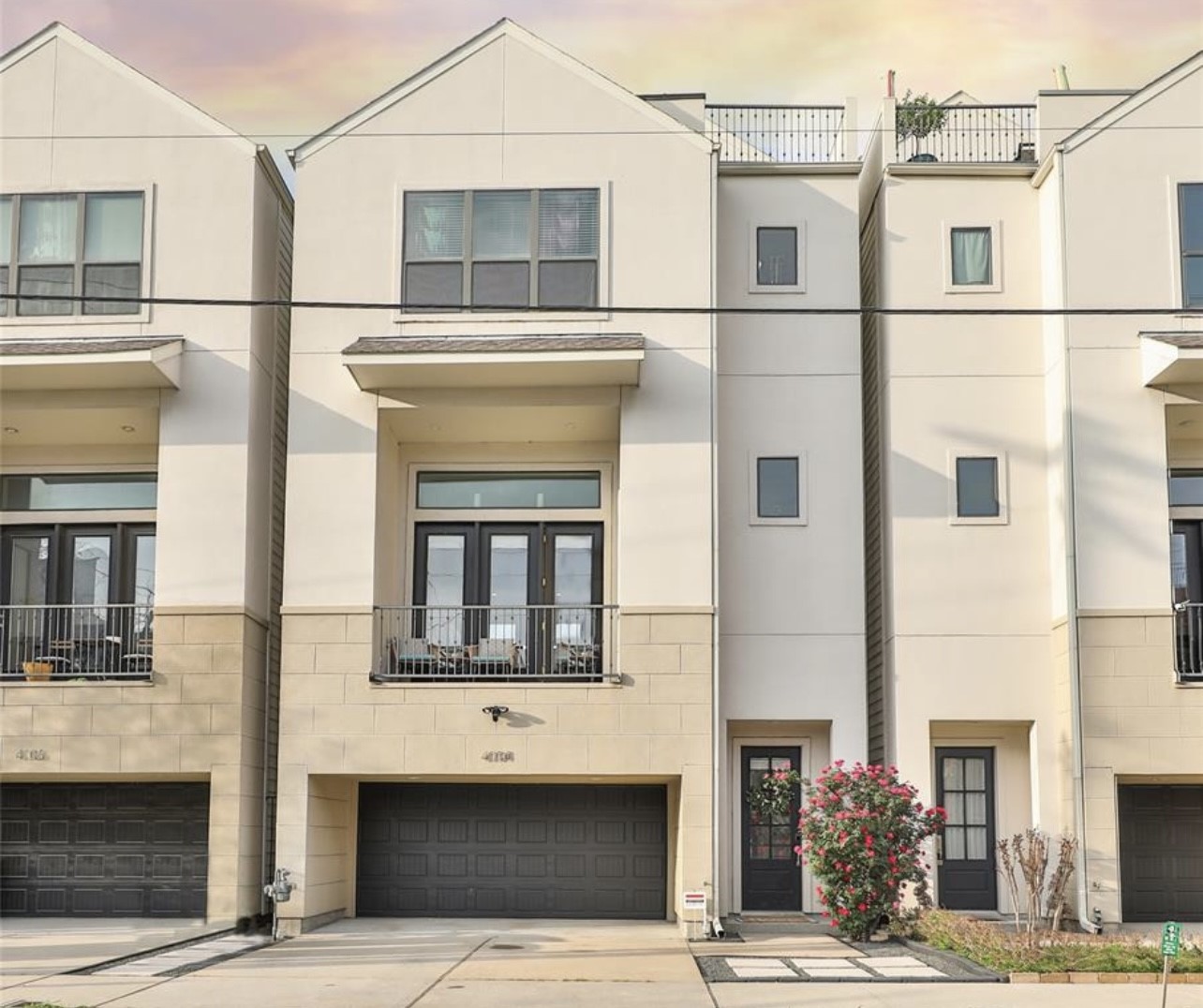 a front view of a building with a garden