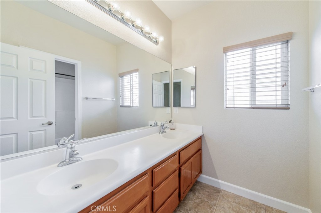 4947 Plumtree Court Riverside, CA 92504 - Photo 34 of 46 The 2nd bathroom with dual sinks and a shower-over-tub