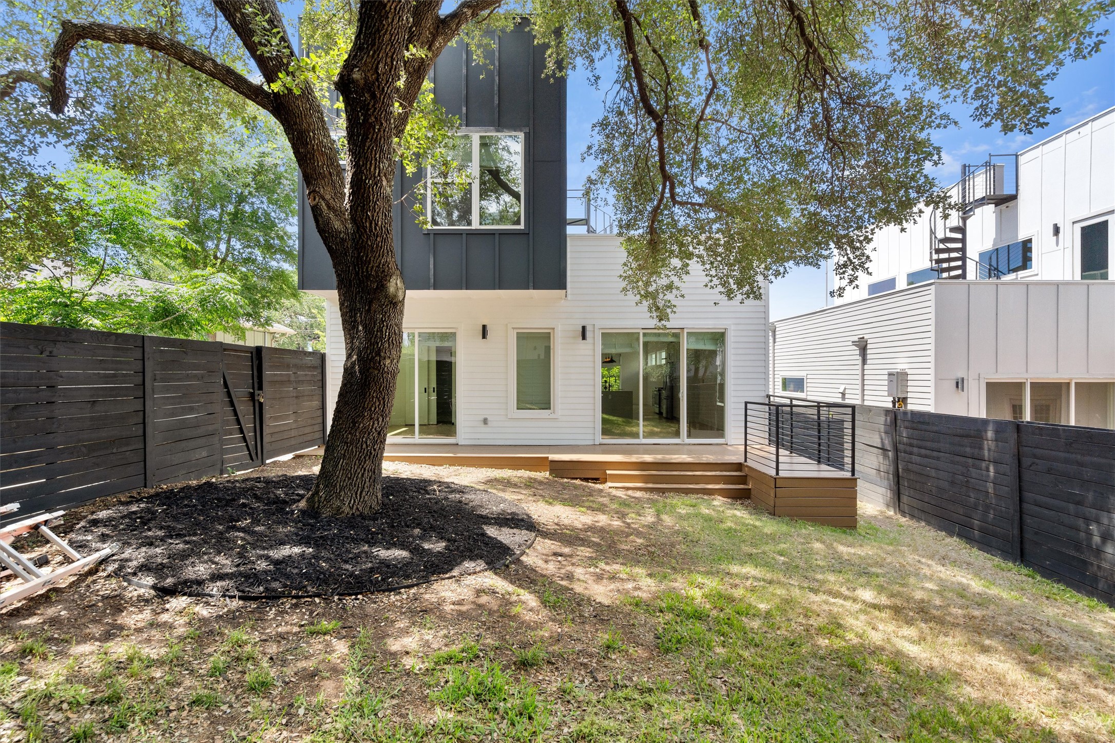 4712 Reyes Street, Unit 1 Austin, TX 78721 - Photo 34 of 38 a backyard of a house with lots of green space