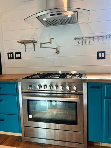 a stove top oven sitting inside of a kitchen