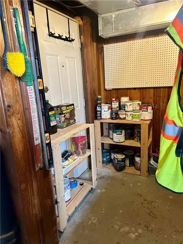 a view of living room with baby crib and furniture