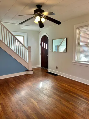 a view of an empty room window and wooden floor