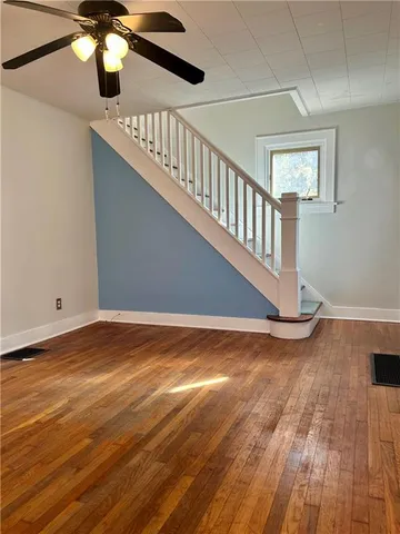a view of an entryway with wooden floor