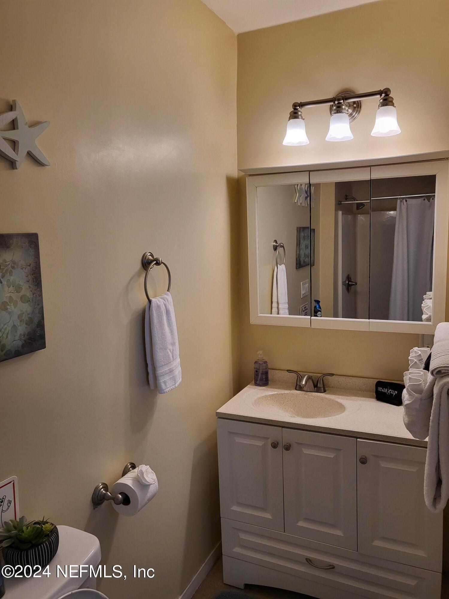 16 Rohde Avenue St. Augustine, FL 32084 - Photo 103 of 114 a bathroom with a sink mirror and vanity
