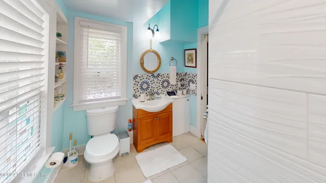 a view of a patio with table and chairs with wooden floor and fence