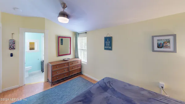a bedroom with furniture and a flat screen tv