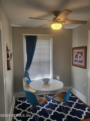 a view of a refrigerator in kitchen and a wooden floor