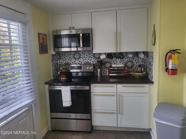a kitchen with a stove and a microwave