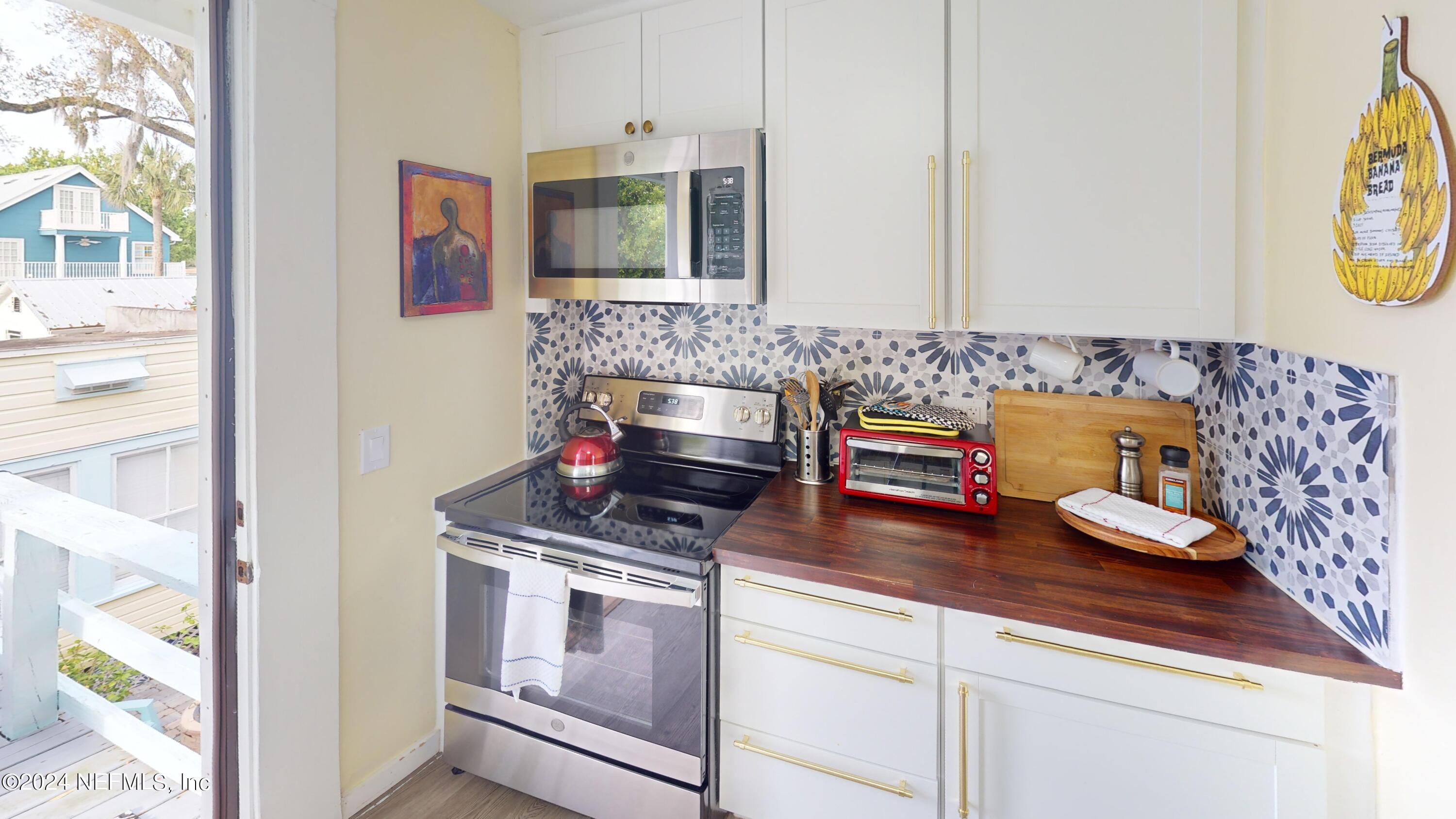 16 Rohde Avenue St. Augustine, FL 32084 - Photo 26 of 114 a kitchen with stainless steel appliances granite countertop a stove and a white cabinets