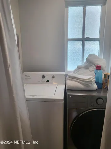 a kitchen with granite countertop a stove and a microwave
