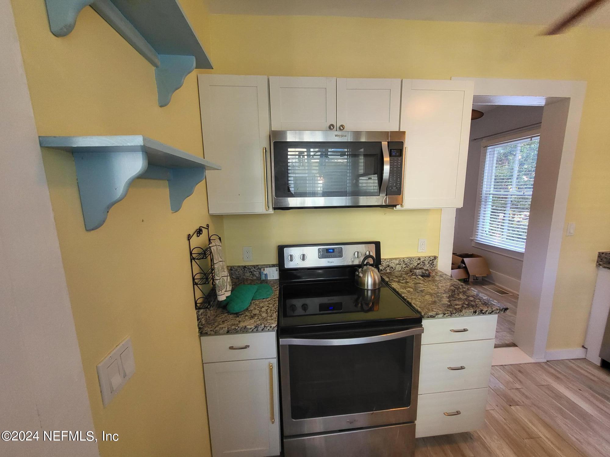 16 Rohde Avenue St. Augustine, FL 32084 - Photo 45 of 114 a kitchen with stainless steel appliances white cabinets and a stove top oven
