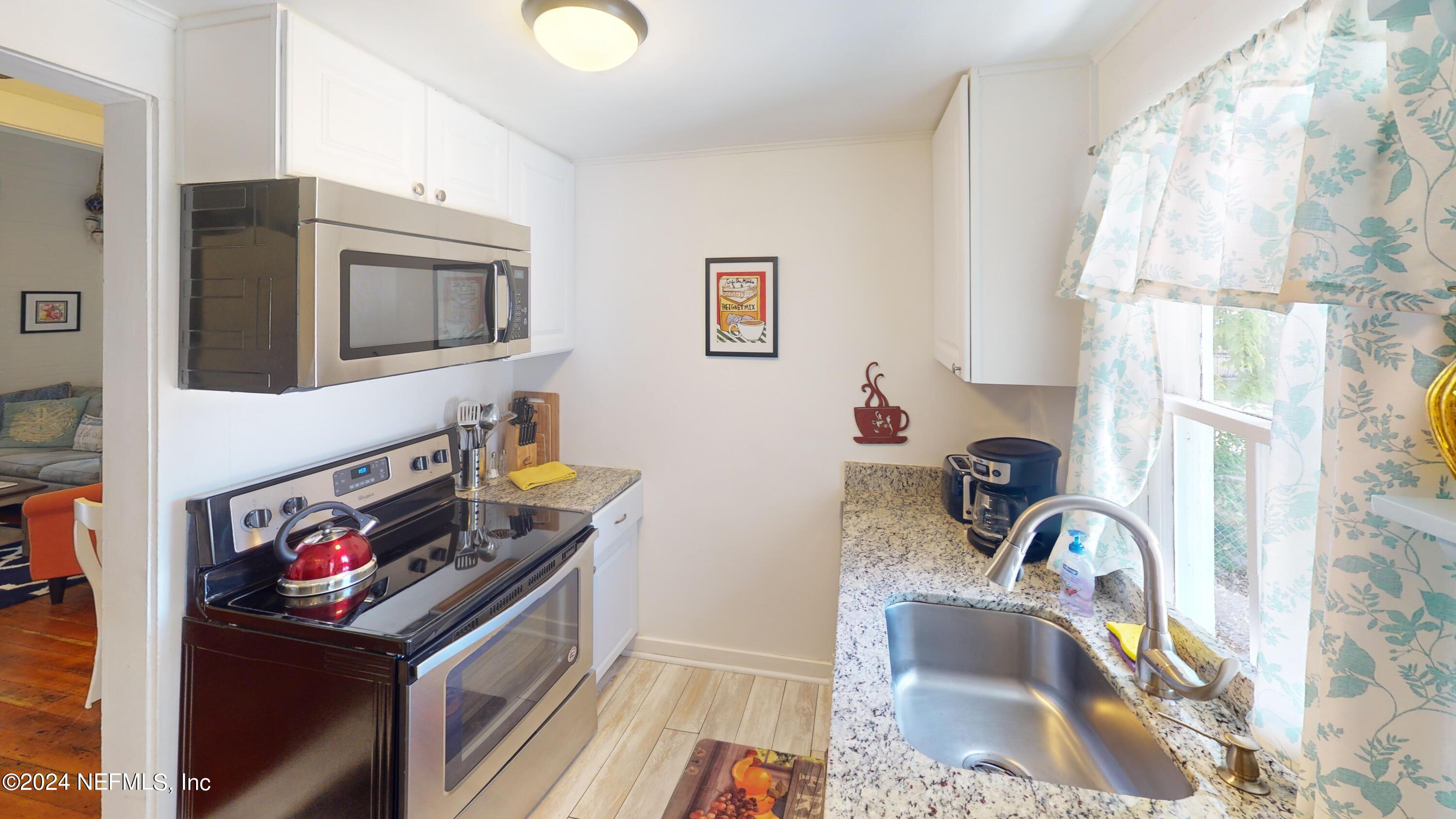 16 Rohde Avenue St. Augustine, FL 32084 - Photo 62 of 114 a kitchen with stainless steel appliances granite countertop a sink stove and a refrigerator