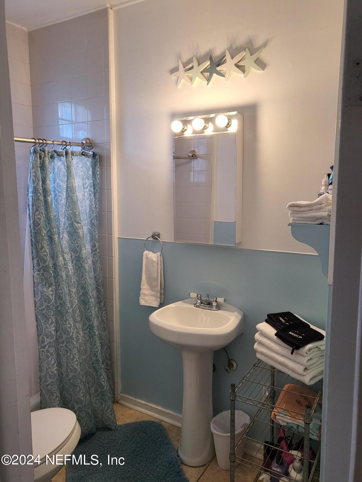16 Rohde Avenue St. Augustine, FL 32084 - Photo 82 of 114 a bathroom with a toilet sink and mirror