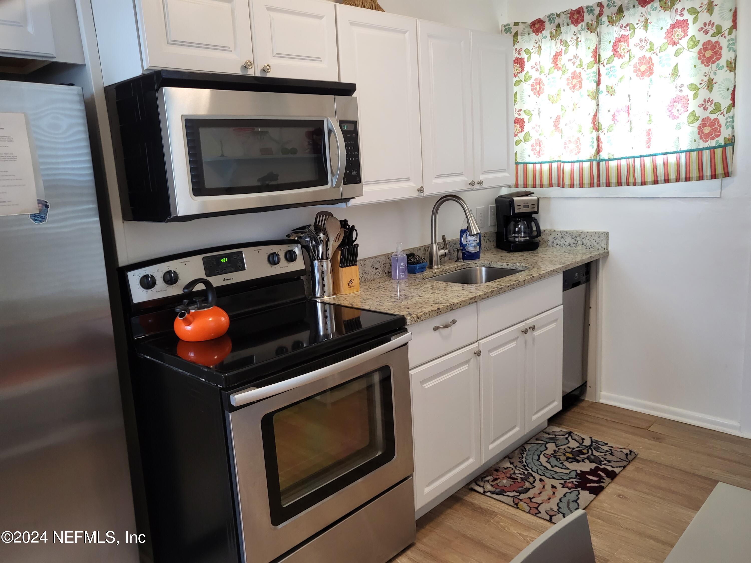 16 Rohde Avenue St. Augustine, FL 32084 - Photo 86 of 114 a kitchen with stainless steel appliances granite countertop a stove a sink and a microwave