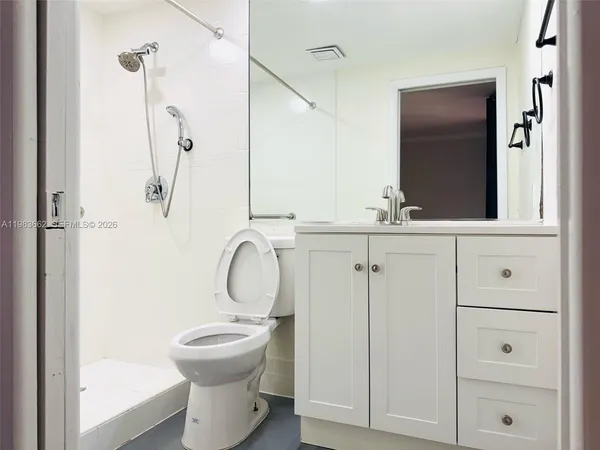 a bathroom with a sink toilet and shower