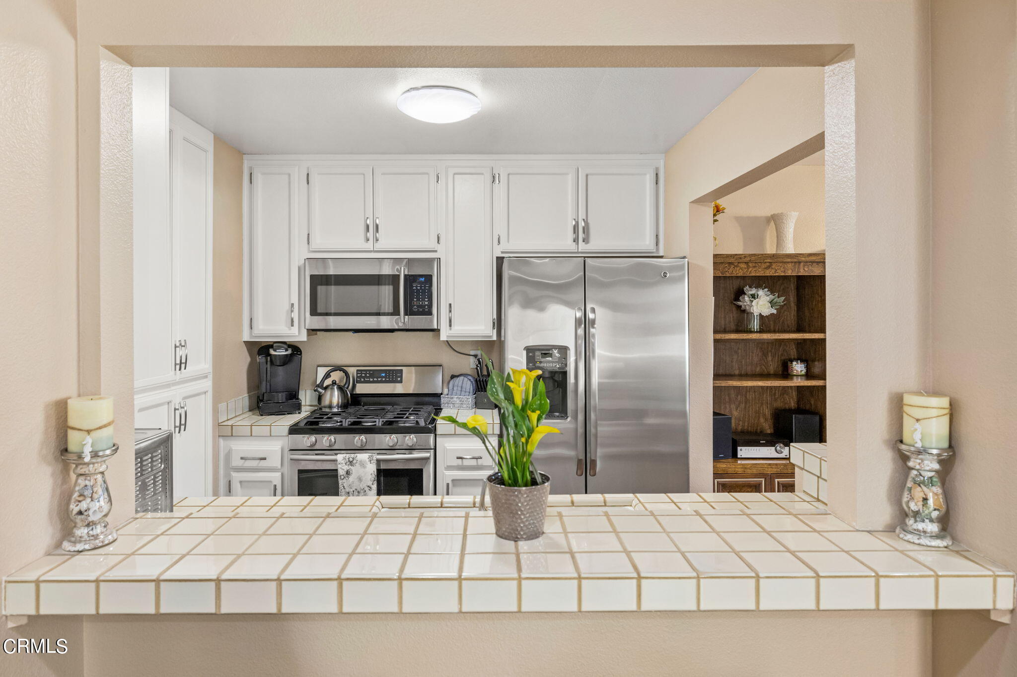 1965 Majorca Drive, Unit 237 Oxnard, CA 93035 - Photo 14 of 50 a kitchen with stainless steel appliances kitchen island granite countertop a refrigerator and a stove top oven