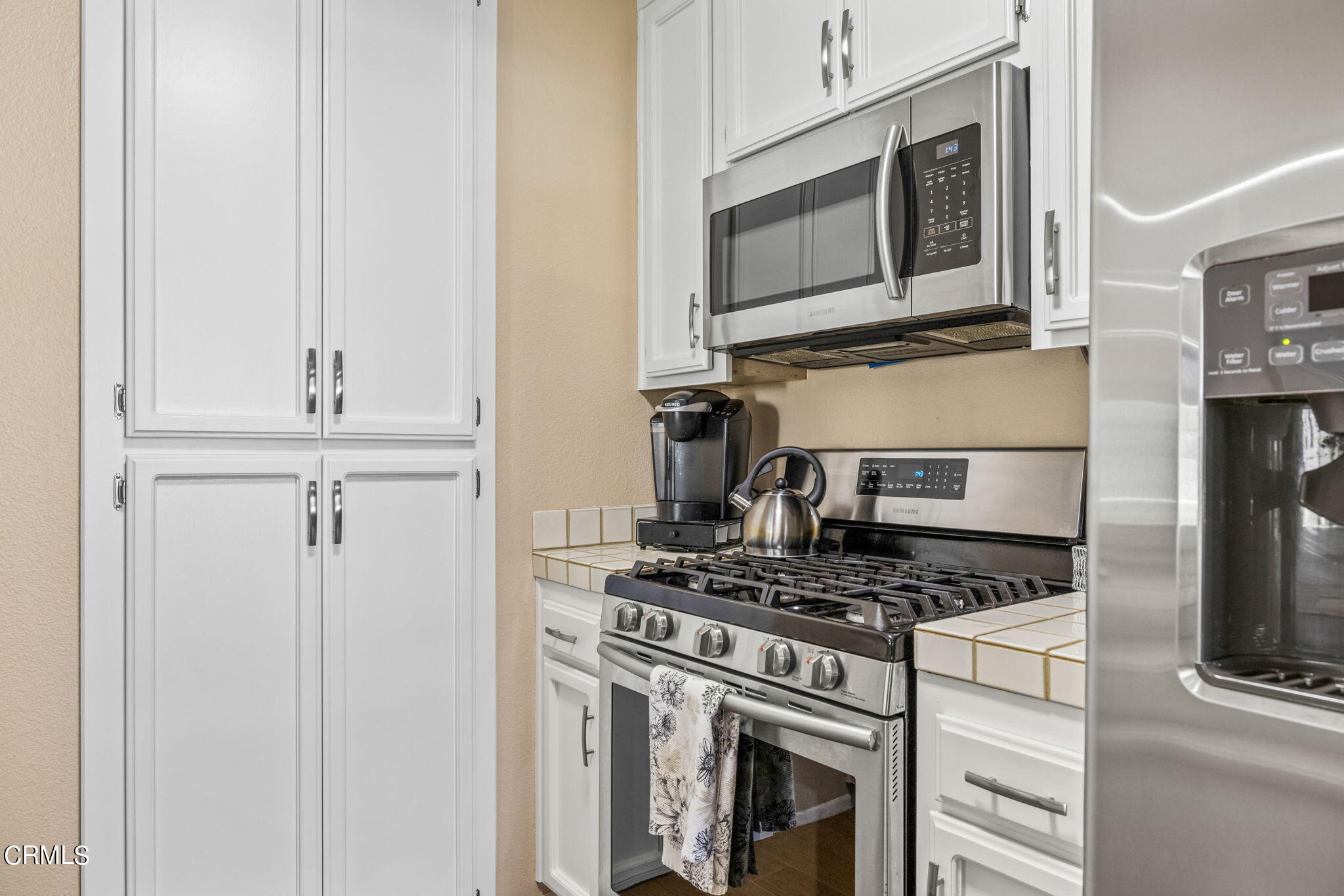 1965 Majorca Drive, Unit 237 Oxnard, CA 93035 - Photo 16 of 50 a kitchen with granite countertop cabinets stainless steel appliances and a wooden floor
