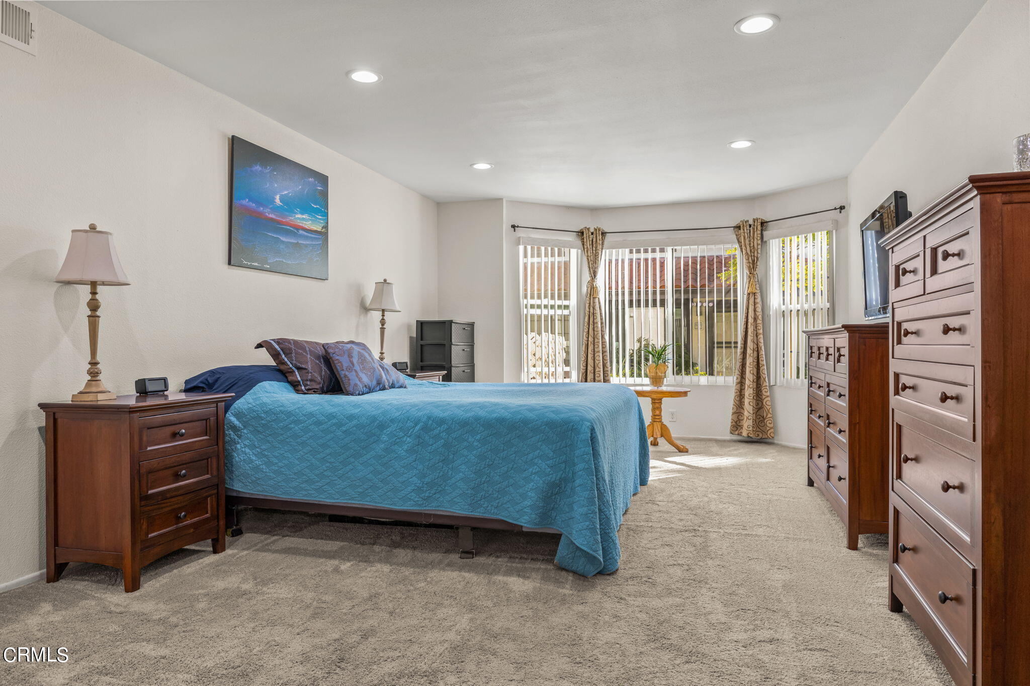1965 Majorca Drive, Unit 237 Oxnard, CA 93035 - Photo 23 of 50 a bedroom with a bed and a flat tv screen on dresser