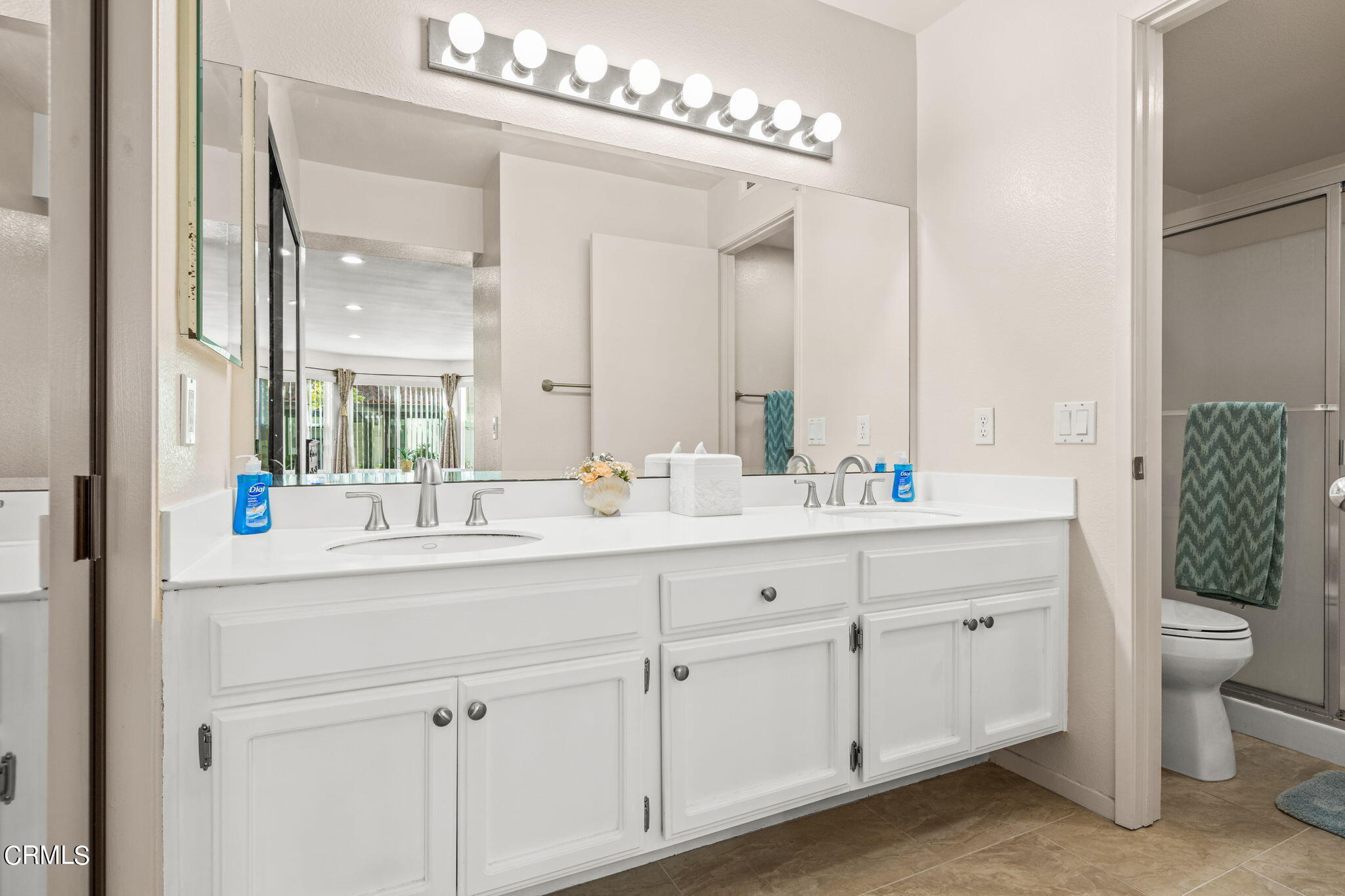 1965 Majorca Drive, Unit 237 Oxnard, CA 93035 - Photo 26 of 50 a bathroom with a double vanity sink and a mirror