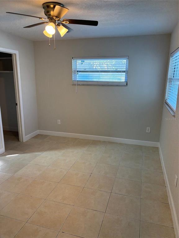 1610 Hinckley Road Orlando, FL 32818 - Photo 4 of 10 a view of an empty room with a window