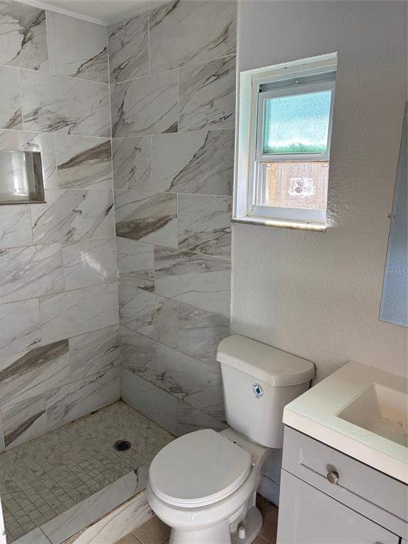 1610 Hinckley Road Orlando, FL 32818 - Photo 5 of 10 a white toilet sitting next to a bathroom sink