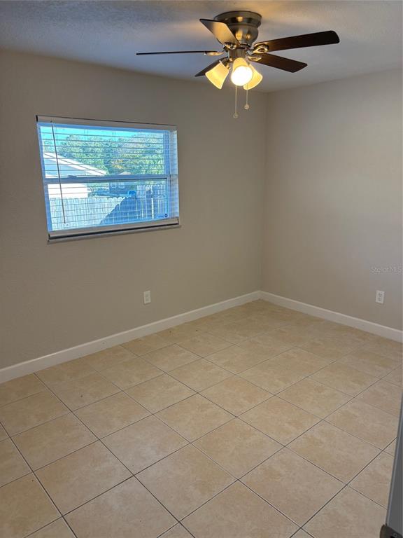 1610 Hinckley Road Orlando, FL 32818 - Photo 6 of 10 a view of an empty room with a window