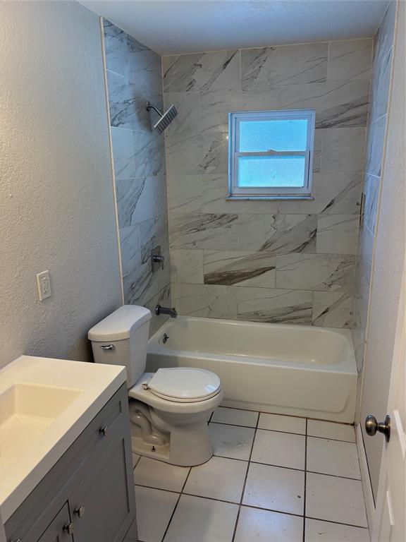 1610 Hinckley Road Orlando, FL 32818 - Photo 8 of 10 a bathroom with a sink a toilet and bathtub