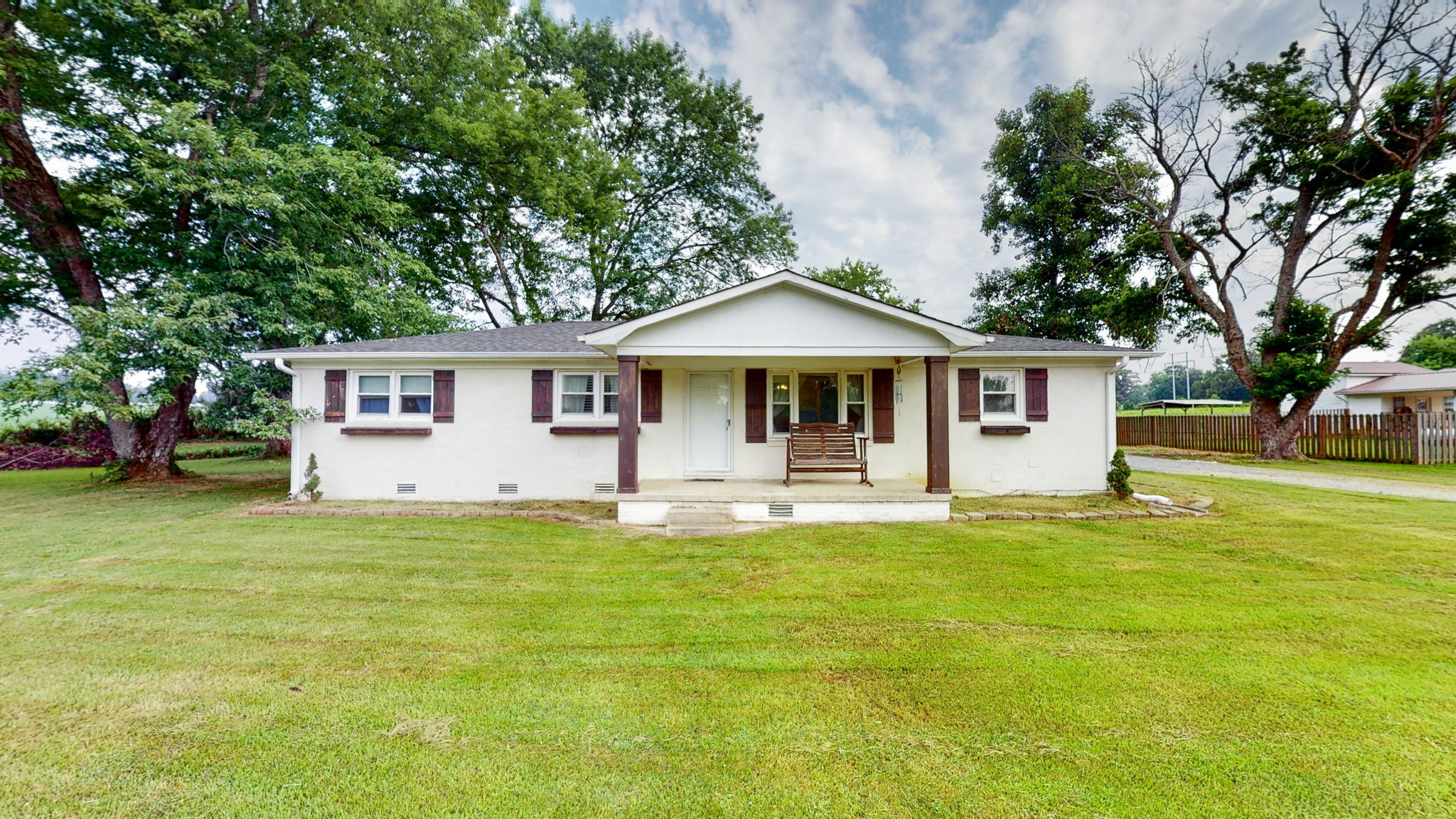 710 Howell Hill Road Flintville, TN 37335 - Photo 1 of 38 a front view of a house with a garden and trees