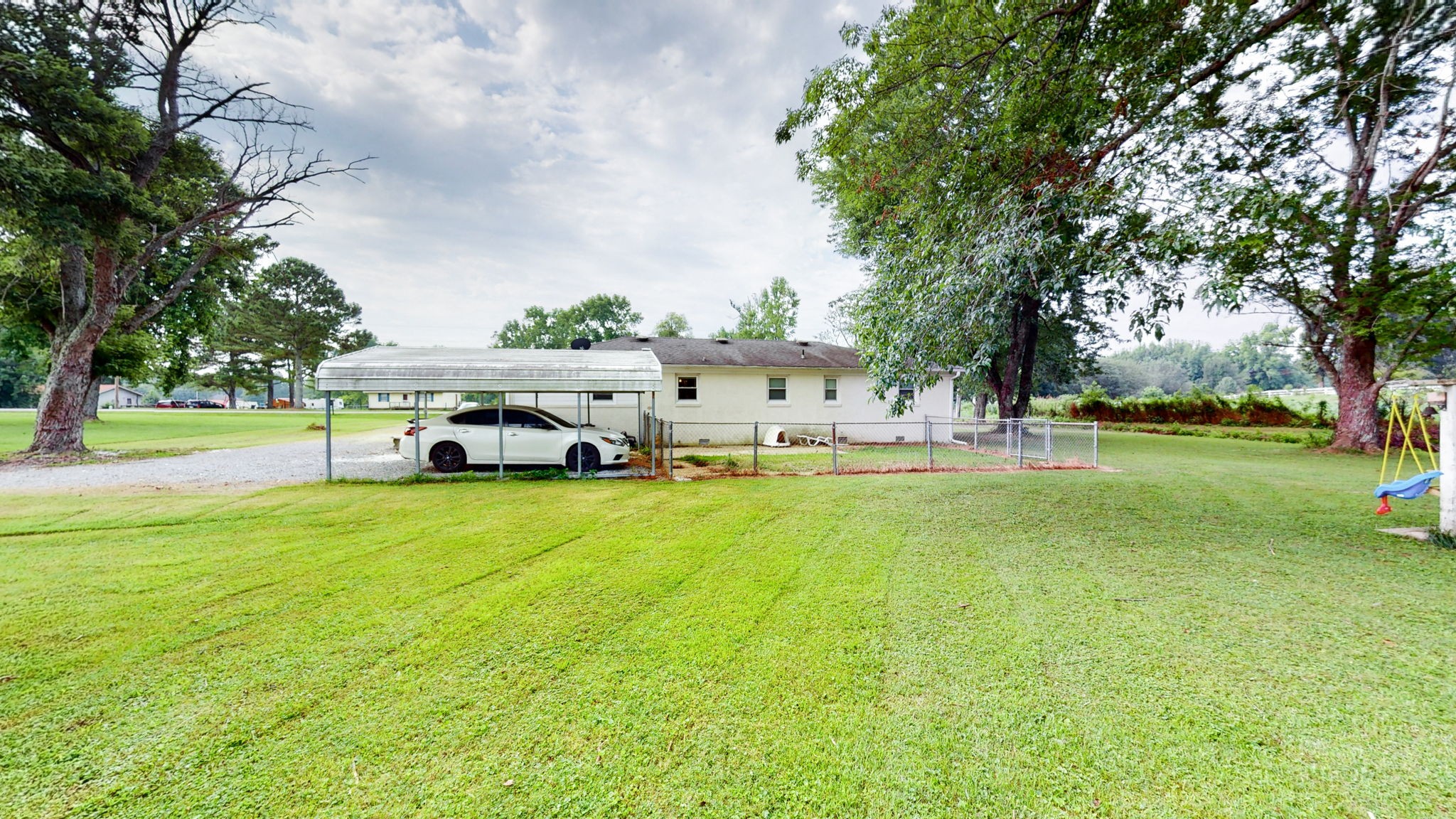 710 Howell Hill Road Flintville, TN 37335 - Photo 29 of 38 a white house with a big yard and large trees