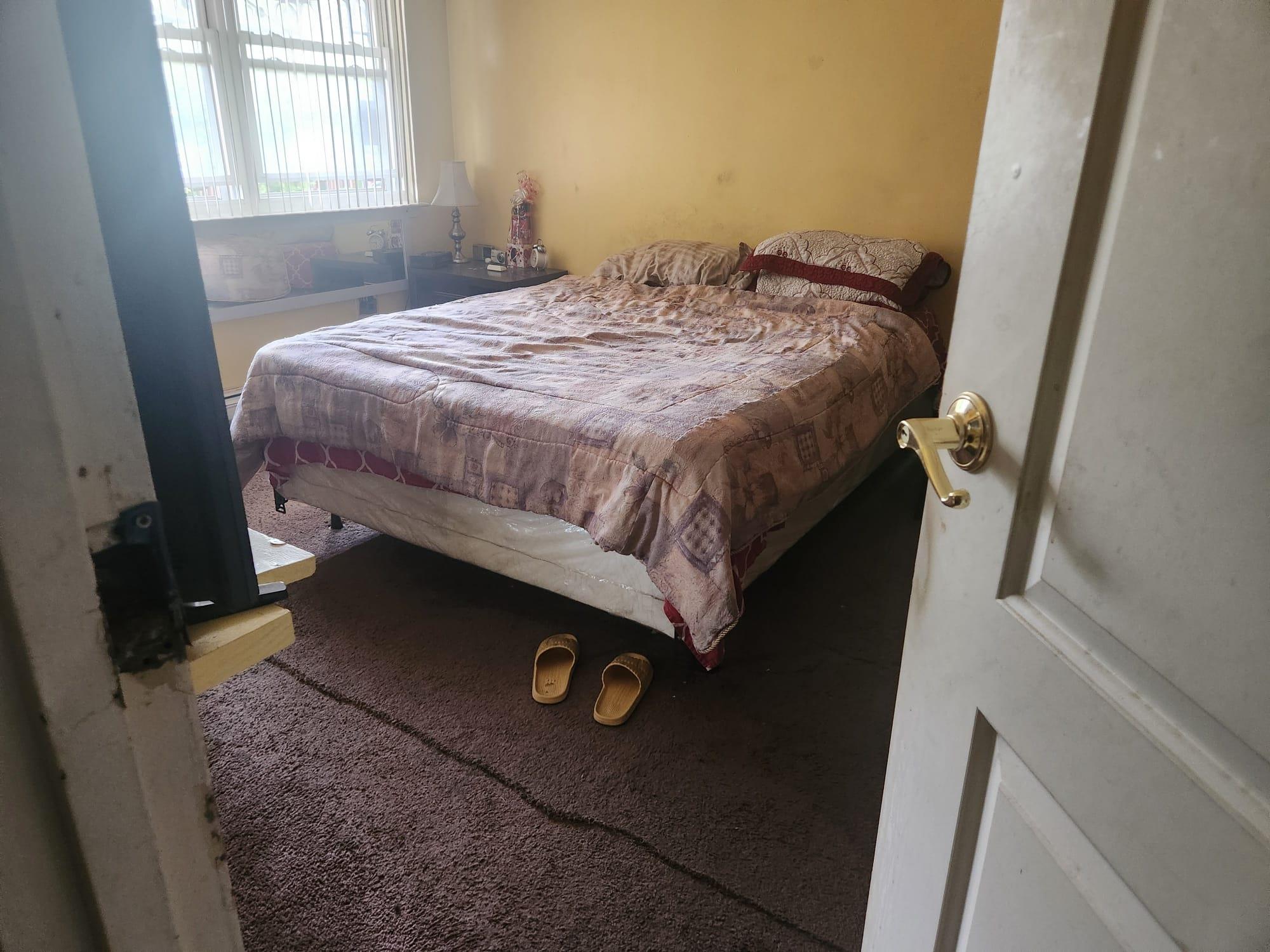 582 Hendrix Street Brooklyn, NY 11207 - Photo 3 of 4 a bedroom with a bed and a window