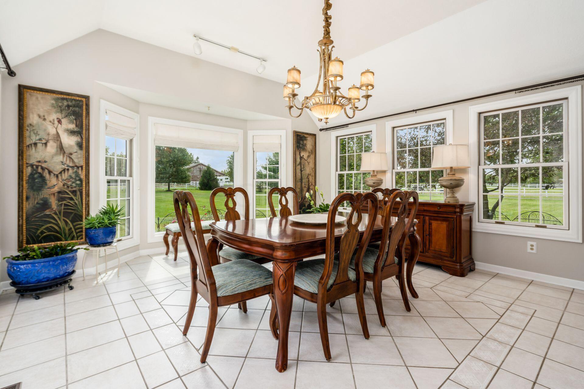 7555 Cook Road Powell, OH 43065 - Photo 17 of 65 Currently used as a dining room. Tile floors, 3 walls of windows! Large opening to the kitchen