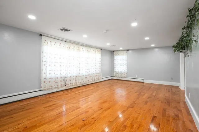 a large kitchen with kitchen island a sink stainless steel appliances and cabinets