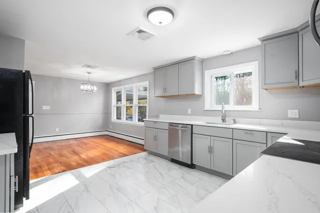 a kitchen with refrigerator and window