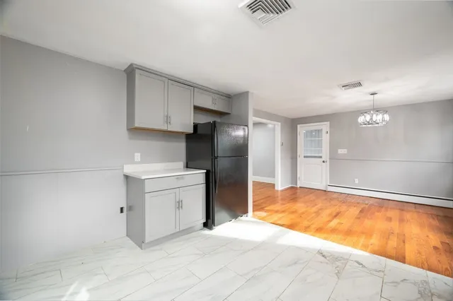 a kitchen with a refrigerator sink and cabinets