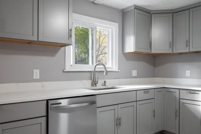 a spacious bathroom with a double vanity sink mirror and toilet