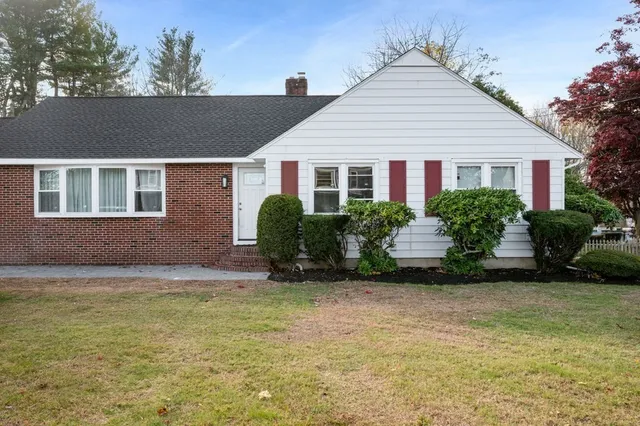 a front view of a house with a garden