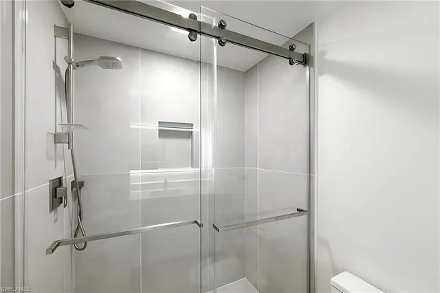 a bathroom with a glass shower door