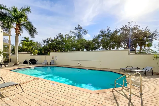a view of a swimming pool and lounge chair