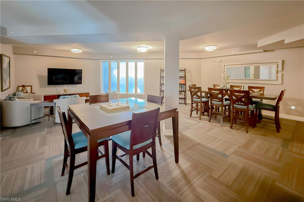 1100 Pine Ridge Road, Unit A106 Naples, FL 34108 - Photo 27 of 27 a view of a dining room with furniture